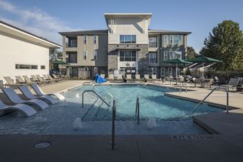 A swimming pool with a building in the background.